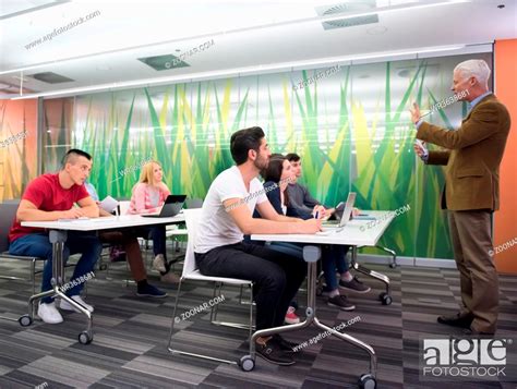 group of students study with professor in modern school classroom ...