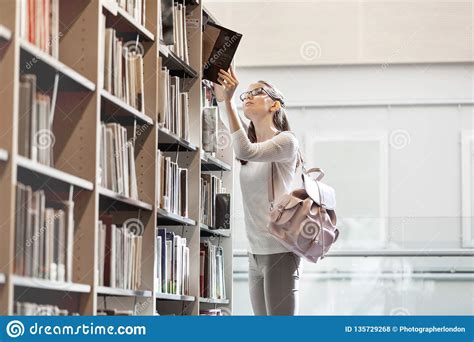 Student Choosing Book At University Library Stock Photo - Image of ...
