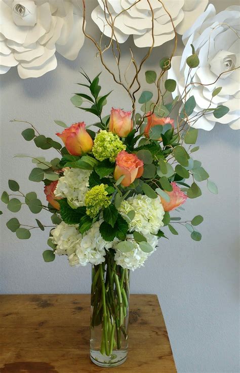 Floral arrangement using Hydrangea, Free Spirit roses, Silver Dollar ...