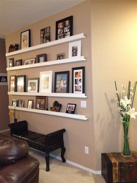 Picture frame collage. easier and cheaper. dollar tree frames painted white or black. IKEA shelf ...