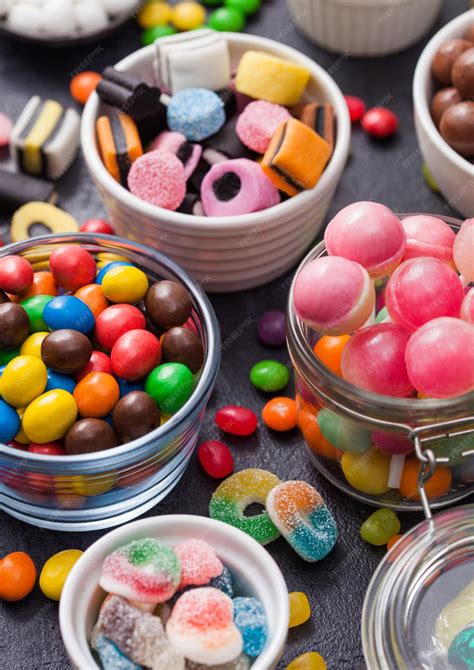 Premium Photo | Pink lollipop candies in jar with various milk ...