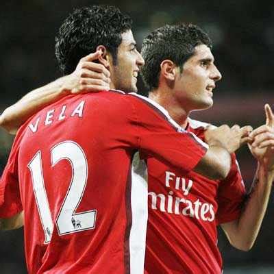 Carlos Vela of Arsenal (L) celebrates with Jack Wilshere after scoring ...