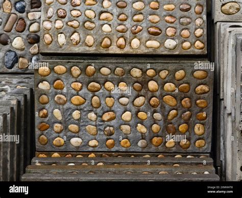 A pile of concrete tiles filled with rocks on top Stock Photo - Alamy