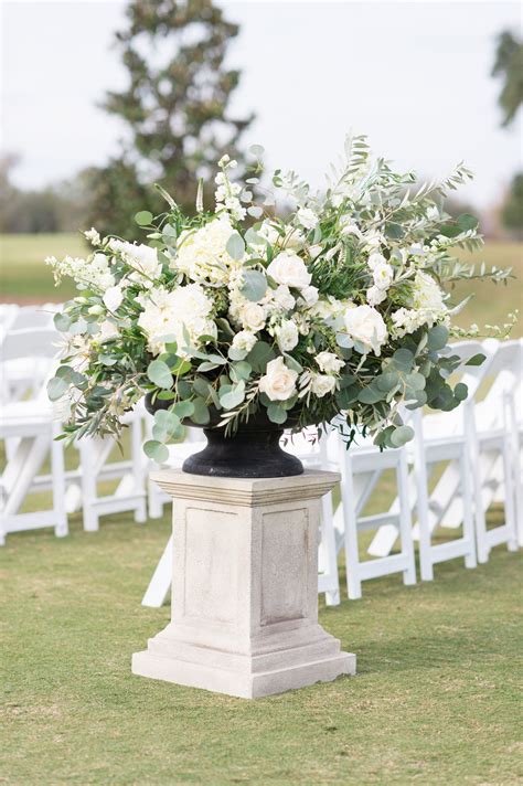 large outdoor wedding arrangement of white hydrangea, white lisianthus ...