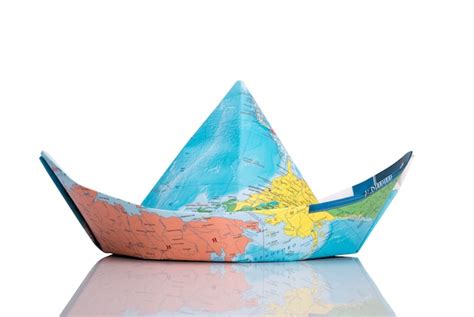 Paper boat made of map. isolated on white | Premium Photo