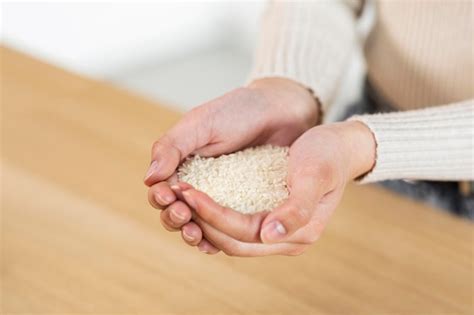 Female hands with handful of rice cropped shot | Premium Photo