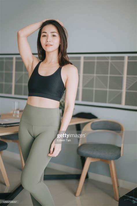 asian chinese beautiful woman with yoga pants and sport bra beside ...