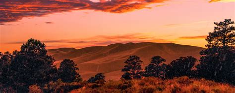 Download wallpaper 2560x1024 trees, clouds, hills, sunset ultrawide ...