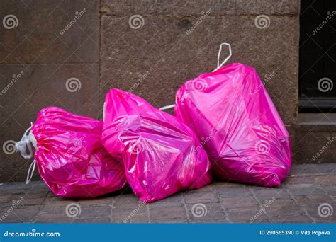 Pink Cellophane Garbage Bags Full of Trash Lie on Sidewalk on City ...