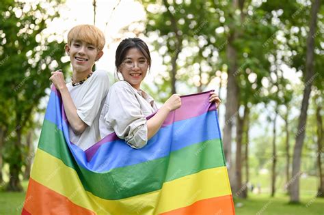 Premium Photo | A young asian woman holding a pride rainbow flag with ...