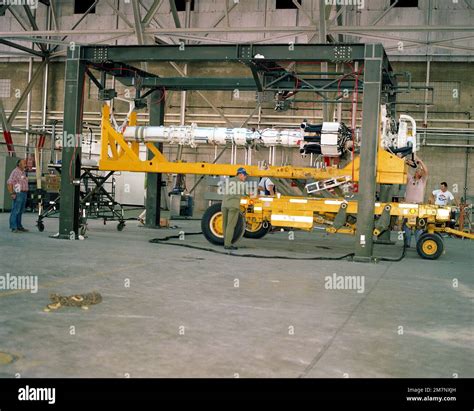 Technicians load an AGM-86 air launched cruise missile (ALCM) on a ...