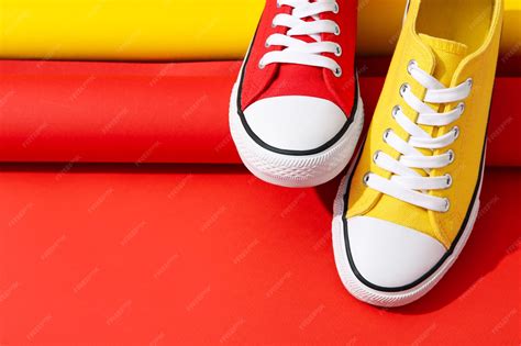 Premium Photo | Concept of shoes red and yellow sneakers space for text