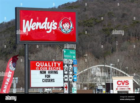 A "now hiring" sign is seen at a Wendy's fast food restaurant in ...