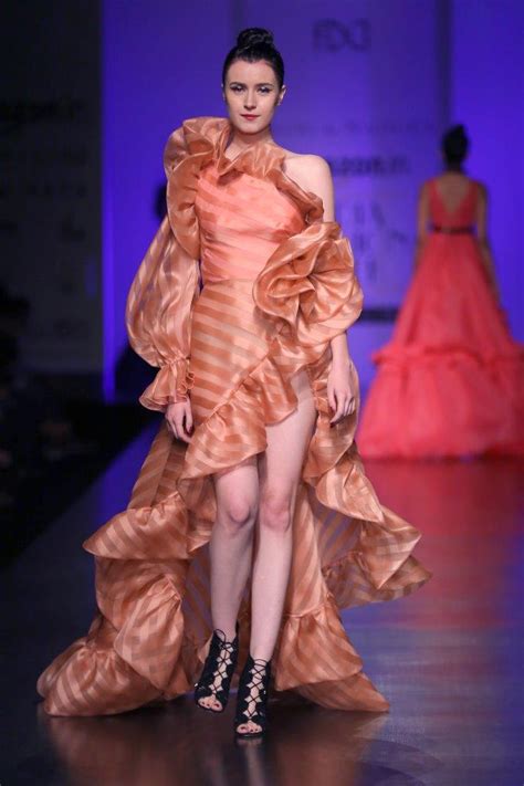 One shoulder over-lapping gown with long pouf sleeve and ruffle detail ...