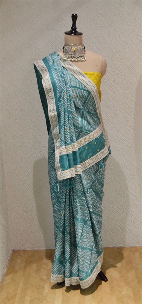 LIGHT BLUE DIAMOND SILK BANDHANI SAREE WITH MIRROR WORK, TASSELS AND B ...