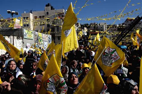 Palestinian Fatah supporters wave flags as they take part in a rally ...