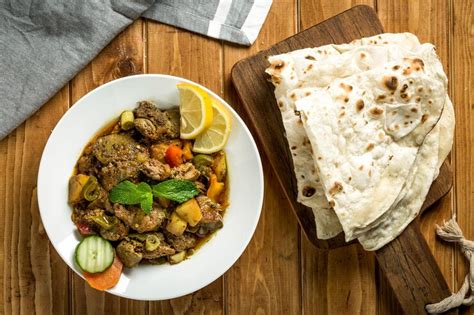 Arabic chicken liver with pita bread served in plate isolated on wooden ...