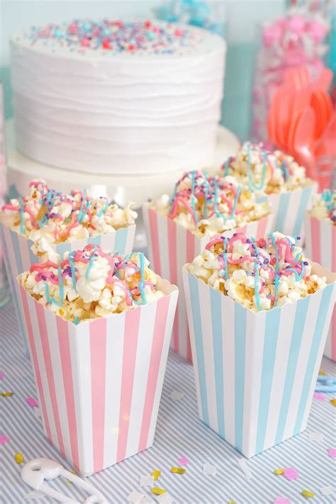 Pink and blue striped popcorn boxes filled with pink and blue drizzled ...