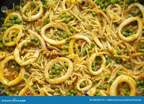Fideua Noodles with Squid and Peas. Recipe for Cooking in Traditional ...