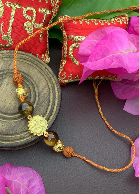 Get Natural Gemstone Tigers Eye With Gold Plated Om And Rudraksha Rakhi ...