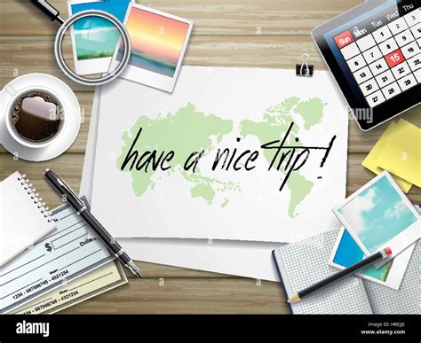 top view of travel items on wooden table with have a nice trip written ...