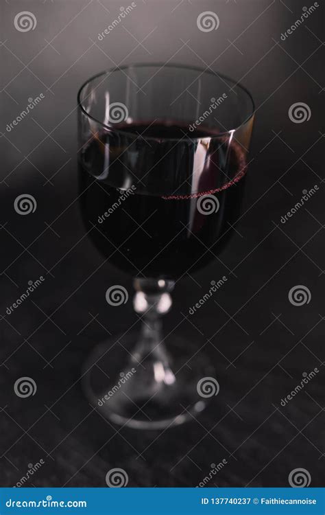 Glass of Intensely Coloured Red Wine on Dark Background Stock Image ...