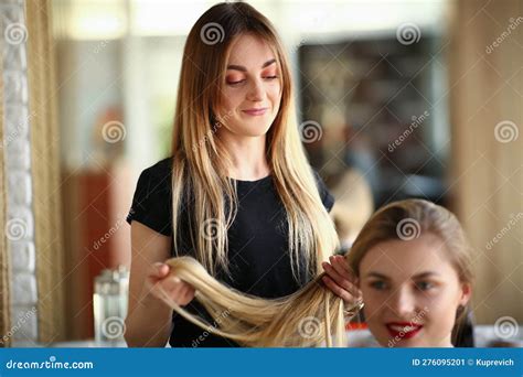 Woman Hairdresser Looks Long Hair Blonde in Beauty Salon Stock Image ...