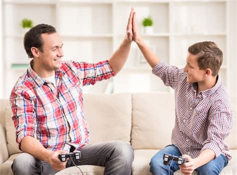 Father and son dressed casual having fun at home. | Premium Photo