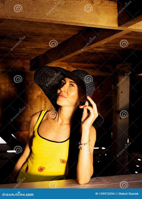 Beautiful Girl in a Yellow Bathing Suit and Hat Stock Photo - Image of ...