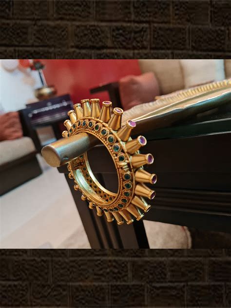 Set of two ruby and green stones sleek openable spike design pacheli's ...