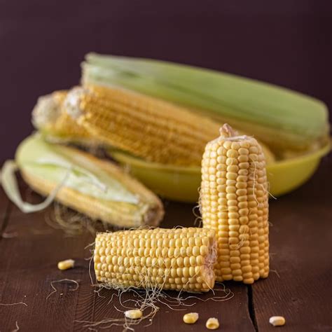 Premium Photo | Grains of ripe corn on wooden background