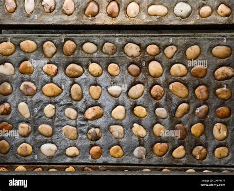 A pile of concrete tiles filled with rocks on top Stock Photo - Alamy