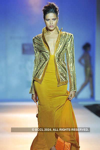 A model walks the ramp to display a creation by designer Rakesh Agarwal ...