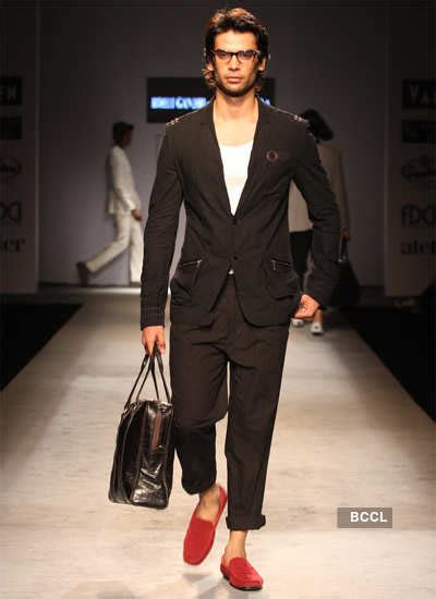 Designers Rohit Gandhi and Rahul Khanna walk the ramp after presenting ...