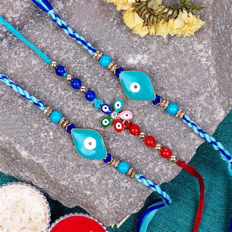 Send Set of 3 Rakhi with Evil Eye Rakhi and Flower Rakhi Online ...