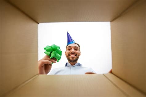 Happy man opening parcel box or birthday gift | Premium Photo