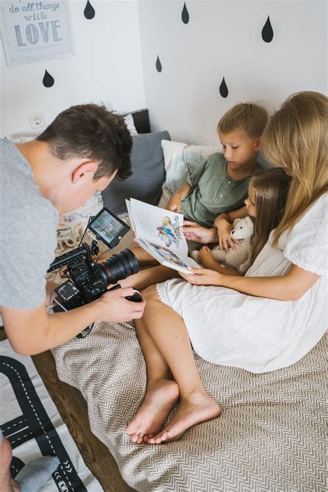 Photographer Taking Photo of Family on Sofa · Free Stock Photo
