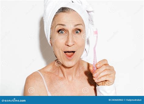 Mature Woman Wrapped in Shower Towel Posing with Toothbrush Stock Photo ...