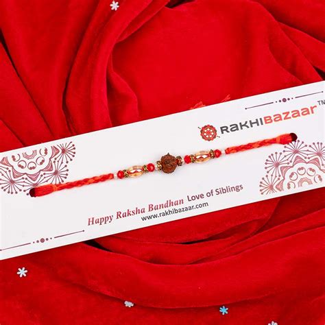 Send Rudraksha Rakhi with Loyka Almond Brittle Assorted Online ...