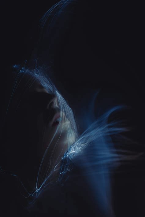 A blurry photo of a woman's face in the dark photo – Free Experimental ...