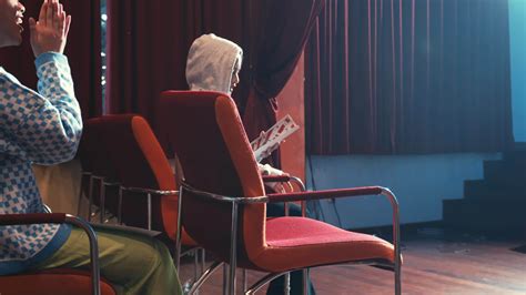 Person practicing public speaking in an auditorium with a single ...