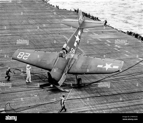 A pranged Grumman F6F Hellcat on the flight-deck of the carrier USS ...