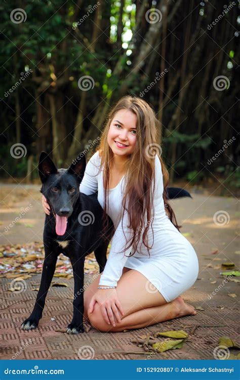 Cheerful Young Girl on Walk in the Park with Her Four-legged Friend ...