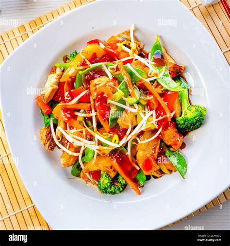 sweet and sour chicken with rice and vegetables Stock Photo - Alamy