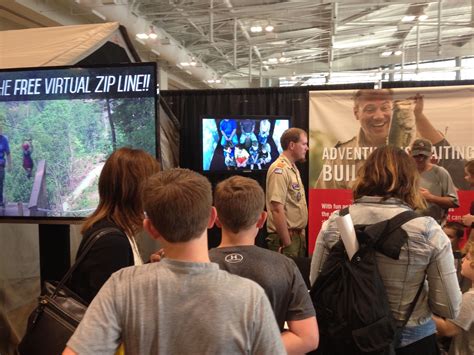 A short line of people wait to try the virtual zipline at the Boy ...