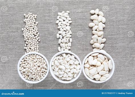 Different Types of White Beans in White Bowls and Scattered on Canvas ...