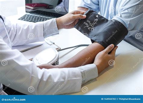 Doctor Using Blood Pressure Monitor and Stethoscope Checking Measuring ...
