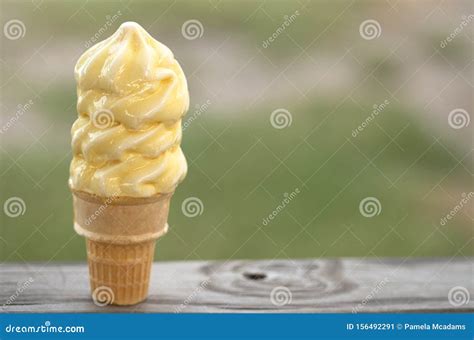 A Vanilla Soft Serve Ice Cream Cone Melting in the Summer Heat Stock ...