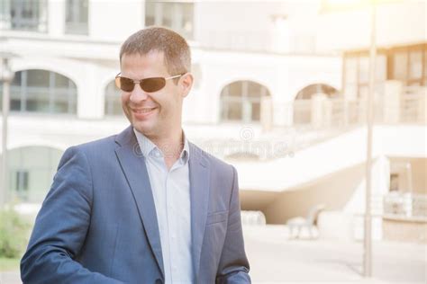 Man in a Business Suit in a Mall Parking Lot 的图像结果