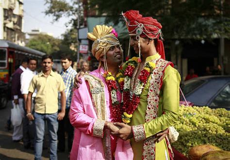 Gay activists dressed as newly wed grooms attend a gay pride parade ...
